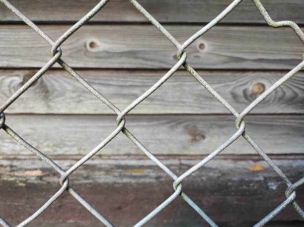istock Wooden Fence and Chain Link Contrast 2244965338
