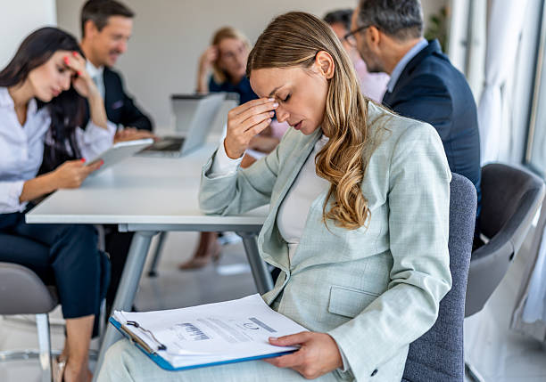 istock Stressed businesswoman suffering headache during office meeting 2244965477