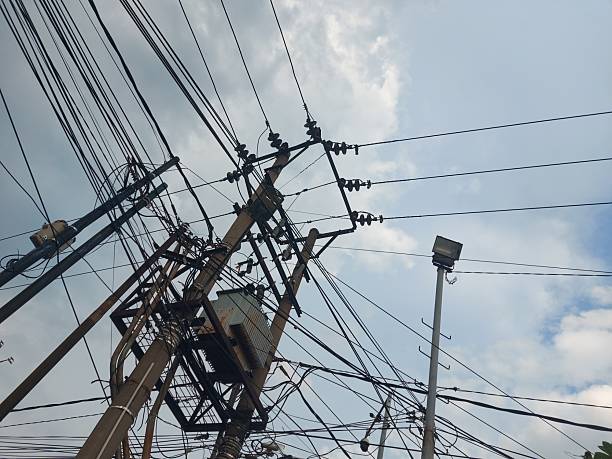 istock High Voltage Power Lines with Transformers and Street Lighting 2244966890