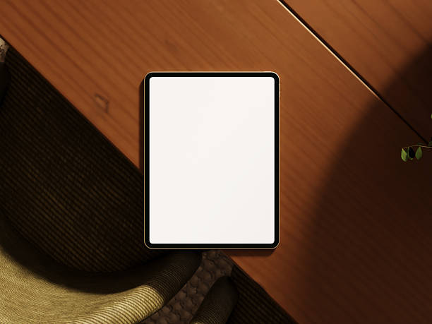 istock Stylish tablet display on wood table with minimalist decor. 2244967003