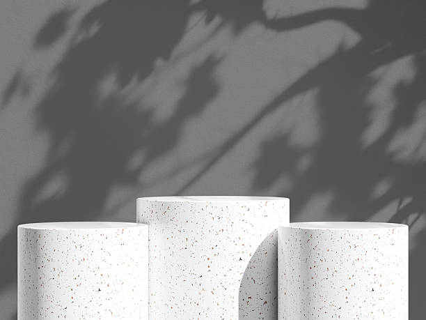 istock Minimalist granite podium trio casting lush shadow play on a dark gray backdrop. 2244967058
