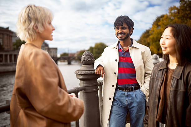 istock Diverse Young Smiling Tourists Chatting on a Bridge with Berlin Cathedral Behind Them 2244970180