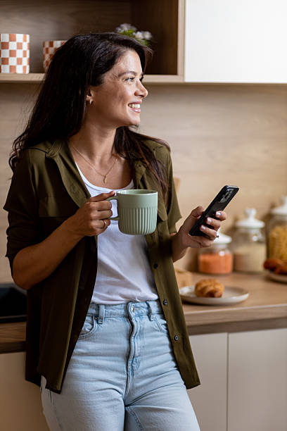 istock Smiling young woman enjoying morning routine at home 2244970346