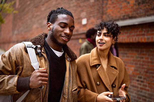 istock Young Diverse Tourists Enjoying Their Berlin Exploration with a Typical Brick Wall in the Background 2244972255
