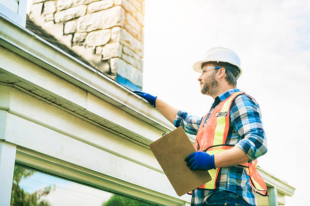 istock man with hard hat standing on steps inspecting house roof 2244973854
