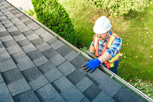 istock man with hard hat standing on steps inspecting house roof 2244973900