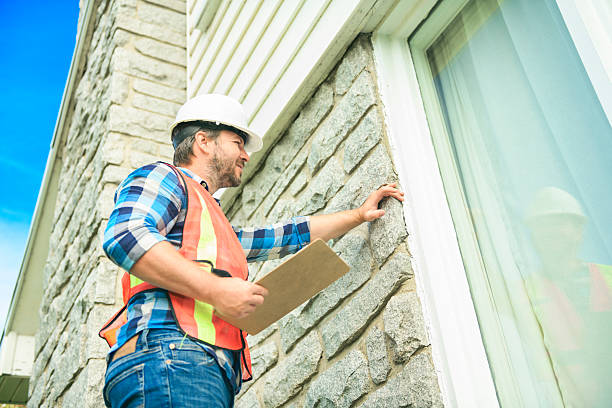 istock worker man with hard hat inspecting house window 2244973917