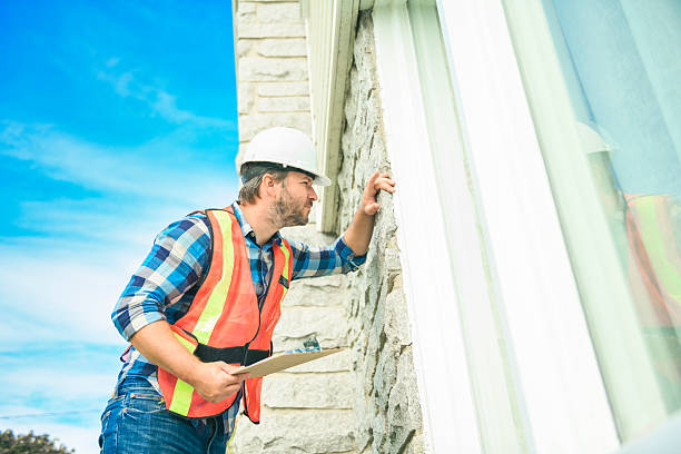 istock worker man with hard hat inspecting house window 2244973918