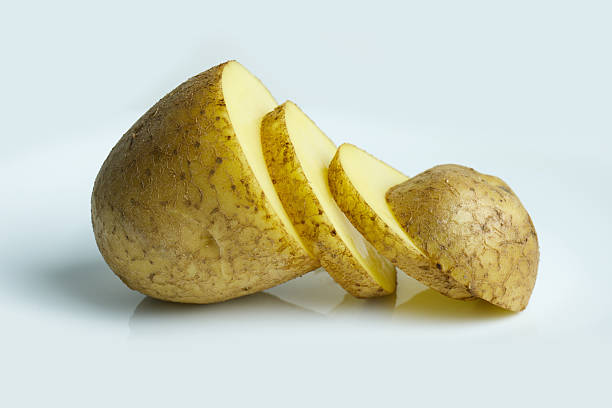 istock Sliced yellow potato pieces on a clean surface 2244974086