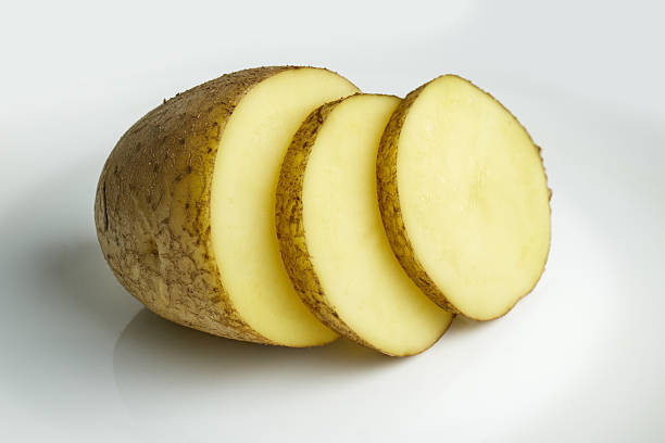 istock Sliced yellow potato pieces on a clean surface 2244974131