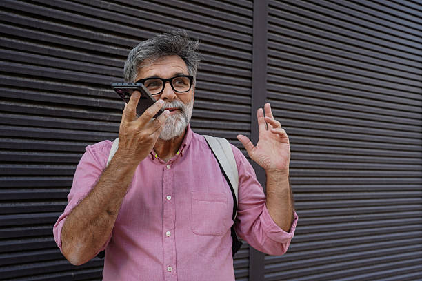 istock Older man using smartphone for calls and voice messages 2244975034