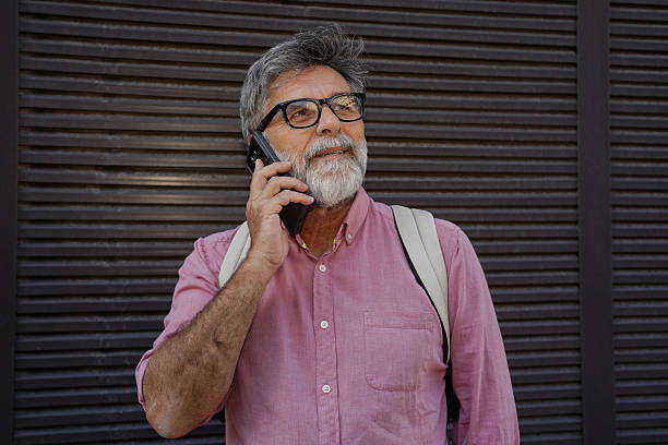 istock Older man using smartphone for calls and voice messages 2244975055