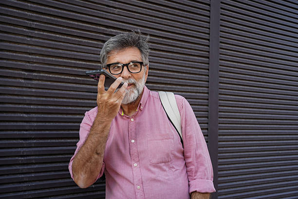 istock Older man using smartphone for calls and voice messages 2244975312