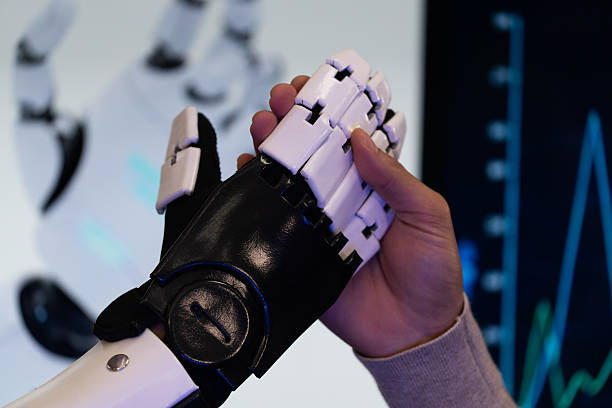 istock Engineer demonstrating advanced robotic prosthetic arm technology with colleague in research lab. Concept of innovation, artificial intelligence, robotics, human-machine collaboration, and future healthcare. 2244975963
