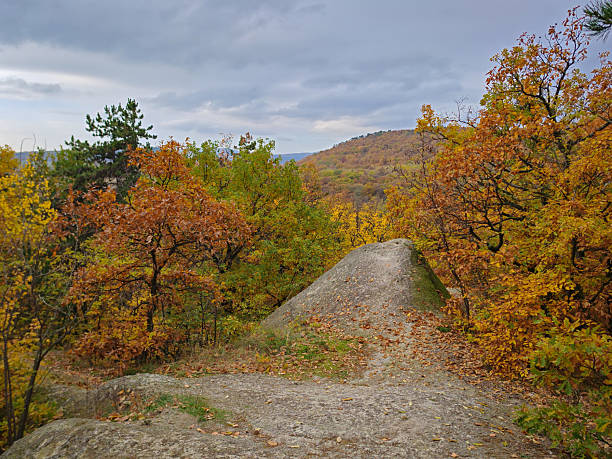 Unique volcanic tuff formation known as the Devil’s Slide (Ördögcsúszda) near Cserépfalu, Hungary. Surrounded by colorful autumn forest in the Bükk Mountains.