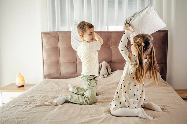istock Siblings having fun with a playful pillow fight 2244983001