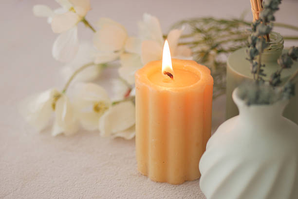 istock Candlelight glowing on serene flowers and greenery 2244983319
