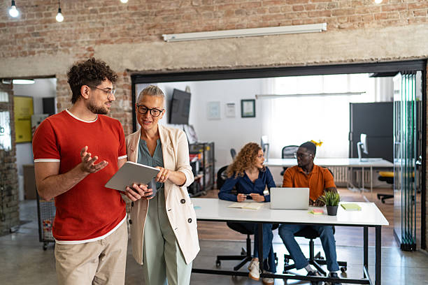 istock Diverse business team collaborating in modern office with digital tablet 2244983609