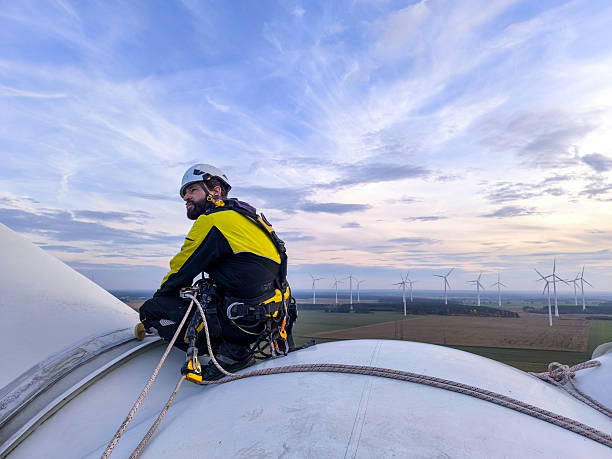 istock Wind Turbine Technician Overlooking the Wind Farm from a Nacelle 2244984280