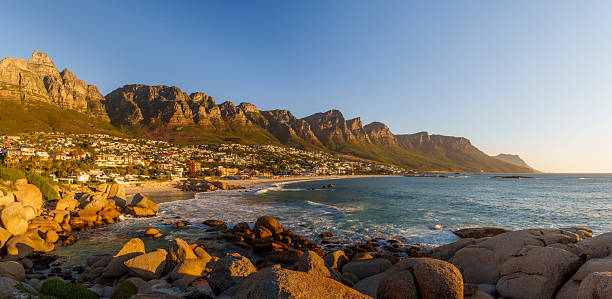 istock Breathtaking panoramic view of Camps Bay's white sandy beach and  Atlantic Ocean, framed by the majestic Twelve Apostles mountain range in the background. Cape Town, Western Cape, South Africa. 2244985321