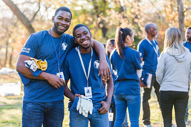 istock Volunteers smiling and working together outdoors, united by a shared cause. 2244985461
