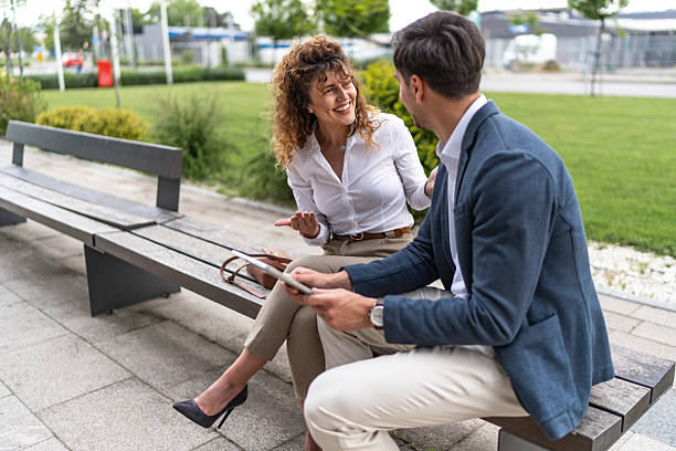 istock Business colleagues sharing ideas and working on tablet outdoors 2244986559