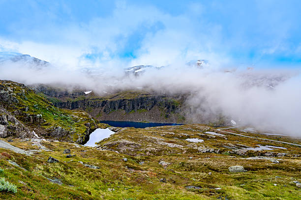 Mountain valley melt water lake Hestadalen in Folgefonna national park Norway with lake, clouds and summer landscape.