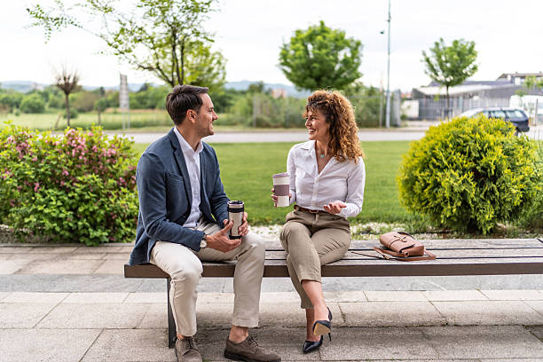 istock Business colleagues having coffee break outdoors talking 2244987267