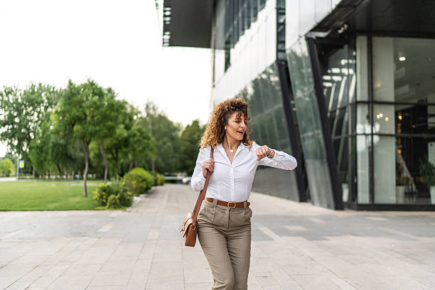 istock Businesswoman checking watch, running late for work 2244987287