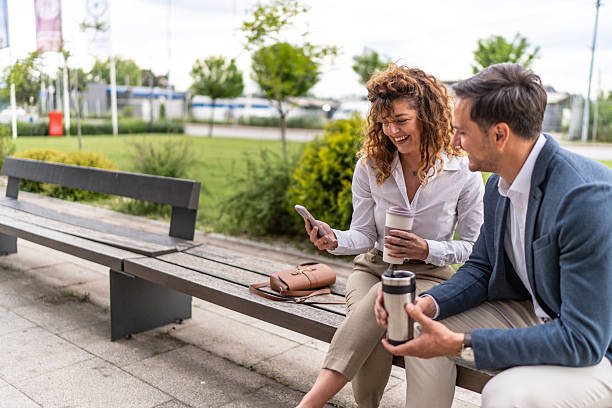 istock Business colleagues enjoying break, laughing, looking at smartphone 2244987306