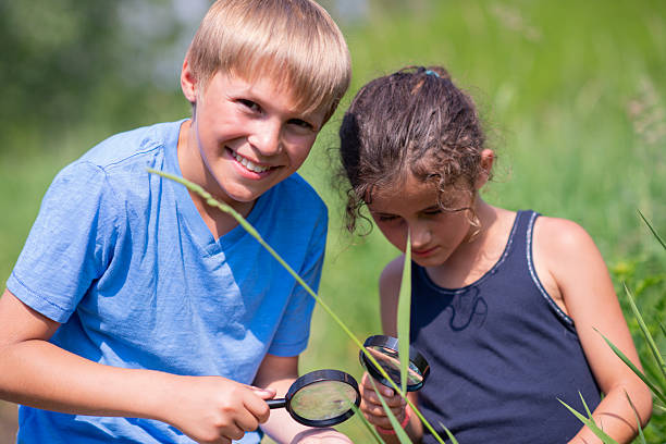 istock Children Exploring Outdoors With Magnifying Glasses, Curious Friends Investigating Nature Together 2244988461