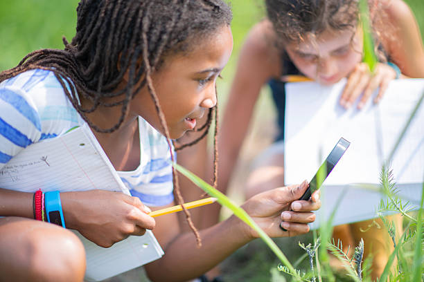 istock Two Kids Exploring Outdoor Science Lesson With Notebooks And Phone In Sunny Field 2244988491