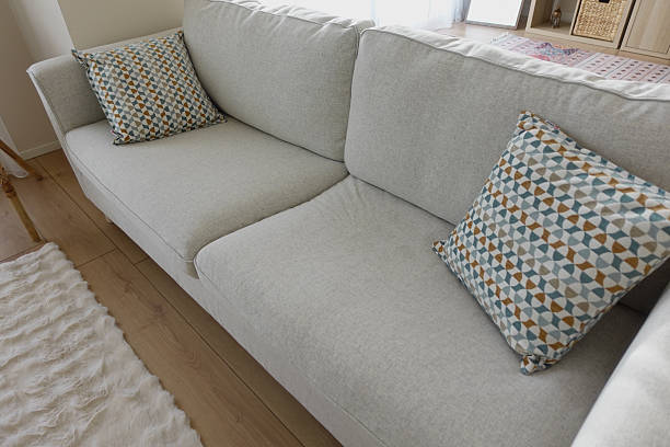 istock Cozy living room sofa with patterned cushions in daylight 2244989317