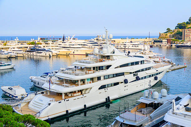 Mimtee is a motor yacht in the Monaco harbour in in La Condamine and Monte Carlo from above during a beautiful summer day. Various yachts and superyachts are moored in the port of the city on the French Côte d'Azur.