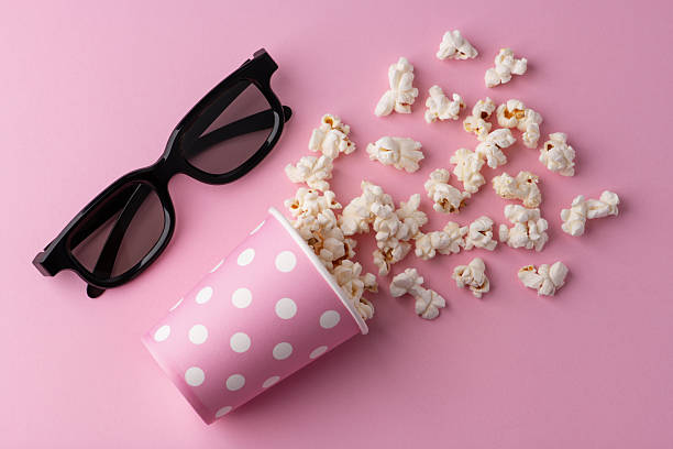 istock Popcorn, cup and 3d glasses on a pastel pink background. 2244990152