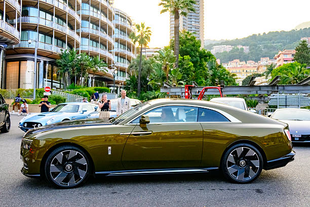 Rolls-Royce Spectre driving on the square in front of the Hotel de Paris Monte-Carlo and the Casino de Monte-Carlo in Monaco. The Spectre is the first all-electric vehicle from Rolls Royce, a full-sized luxury grand tourer