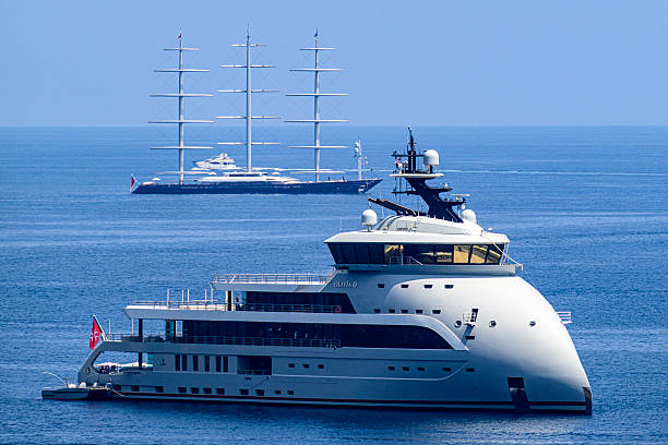 Yachts, including the Olivia O in the Mediterranean sea in the bay at Monaco and Baie de Roquebrune during a beautiful summer day on the Côte d'Azur.