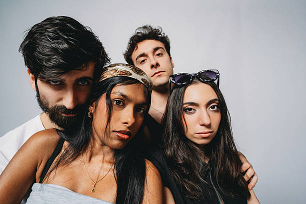 A stylish female dance crew is posing for the camera in a studio in a wide angle above the point of view.