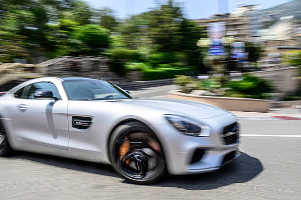 Mercedes-AMG GT Coupe driving on the street of Monte Carlo in the Grand Hotel Hairpin of the Monaco race track. Panning photo with motion blur.