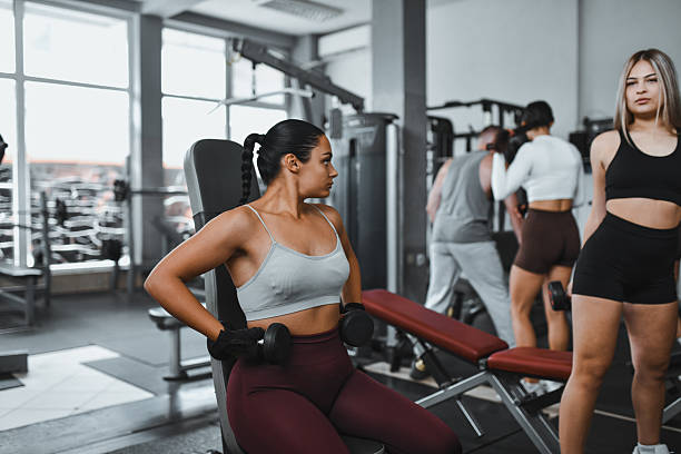 istock Fitness Class In Progress: Women Training With Dumbbells In A Modern Gym Studio 2244990781