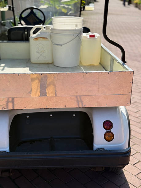 istock Maintenance cart carrying cleaning supplies on a sunlit brick path, with open space for copy 2244993519