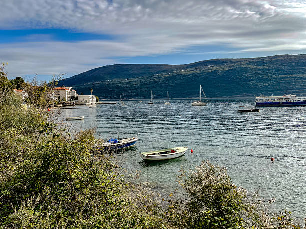 istock serene seaside harbor with moored vessels, peaceful waterfront scene featuring boats and coastal 2244994271
