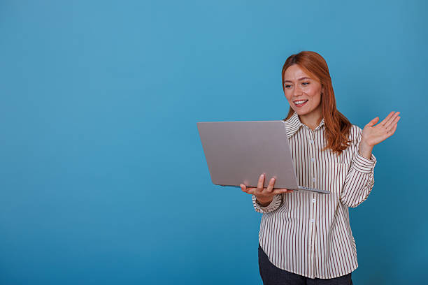 istock Woman on a video call using a laptop, smiling and gesturing, representing online communication and remote work 2244997892