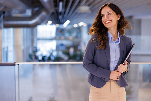 istock Confident businesswoman smiling in modern office environment 2244998099