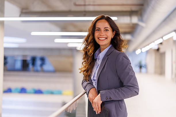 istock Smiling businesswoman standing confident in modern office 2244998135