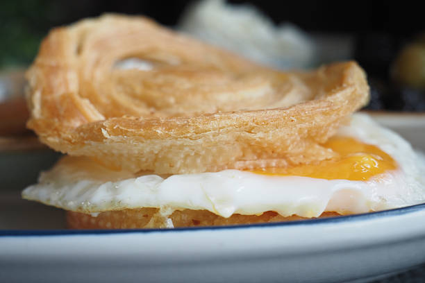 Egg yolk resting on crispy pastry creates a tempting breakfast dish.