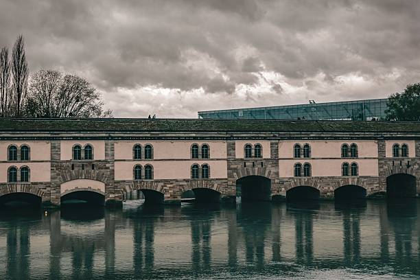 istock Dramatic View of Strasbourg's Historic Ponts Couverts on an Overcast Day 2244999619