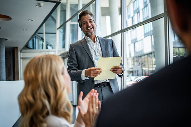 istock Speaker receiving applause after successful business presentation 2245002456