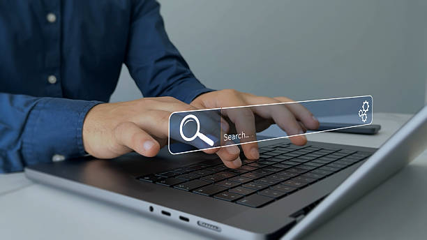 istock Businessman hands clicking internet search page on touch screen. Searching information on internet.Searching the internet helps find information, connect ideas and explore digital knowledge. 2245003514