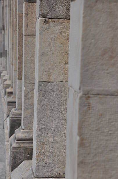 istock Close view of historical stone columns lining a walkway in an ancient architecture setting during daylight hours 2245003704